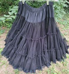 Fluffy, feminine, black square dance petticoat/slip/crinoline made of a dotted tulle edged in 1" wide lace. This is really a petticoat that's meant to be seen. It's so pretty. I think you could turn this into a skirt by itself depending on what you wore under it. Two layers of 3 rows.  From the Great American Square Dance Company. Guessing it's a medium or small. See measurements.  Hand wash/Line dry. This has been laundered. Elastic feels a little stretched out, but still has plenty o Black Summer Petticoat For Costume Party, Flowy Tiered Petticoat With Attached Cancan, Black Petticoat For Costume Party In Spring, Spring Black Petticoat For Costume Party, Black Spring Petticoat For Costume Party, Black Petticoat For Spring Costume Party, Lace Tiered Petticoat With Attached Cancan, Black Lined Summer Petticoat, Shop Square Dance Petticoat