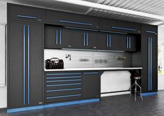 a garage with black cabinets and blue trim