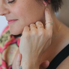 a close up of a person wearing rings