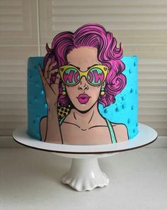 a colorful cake with a woman wearing sunglasses on it's face and holding her hand up to the side