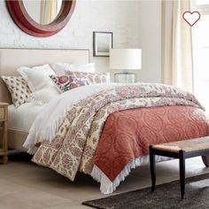 a bedroom with white brick walls and red bedding