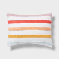 a white pillow with multicolored stripes on it