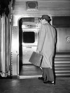 size: 12x9in Photographic Print: 1950s BACK VIEW OF A MAN BUSINESSMAN CARRYING LEATHER BRIEFCASE WEARING TOP COAT AND HAT COMMUTE... by Panoramic Images : 1950s Man, 1950s Men, 1950s Mens, Mystery Dinner, What Is An Artist, Vintage Business, Vintage Suits, Briefcase For Men, Back View