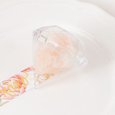 a piece of cake sitting on top of a white plate next to a glass container