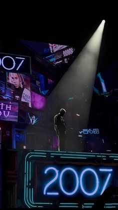 a man standing on top of a stage in front of a crowd