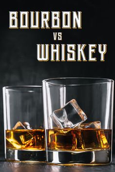 two glasses filled with whiskey sitting next to each other