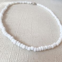 This white seed-beaded choker is super cute to add a pop of color to any outfit or to go with any occasion! Its made with beading wire (non-stretchy). The standard choker length is 15 inches long. If you message me on Instagram or Etsy I can make the choker smaller or bigger to fit you. For best care stay away from water! Size: 15 inches long Things included in your package (bubble mailer) : -your order -thank you card -extras (stickers or candy) Make sure you follow my Instagram @jewelrybynausheen for amazing jewelry posts and shop updates! Minimalist White Choker For Everyday, Minimalist White Everyday Choker, Everyday Minimalist White Choker, White Necklaces With Tiny Beads For Everyday, Simple White Round Bead Jewelry, Simple White Round Beads Jewelry, Everyday White Single Strand Beaded Necklace, White Summer Jewelry For Everyday, Adjustable White Choker For Everyday Wear