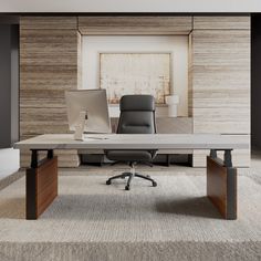 an office desk with two laptops on it and a chair in front of it