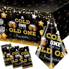 a black and gold birthday party table cover with two beer mugs, one for the old