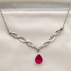 Sterling Silver Diamond Swirl Ruby Necklace Stunning! ( 16" Chain With Lobster Closure, Marked .925) This Is Truly A Beautiful And Fun Piece. The Accent Diamonds Give That Perfect Frame Of Sparkle To The Two Carat Pear Shaped Ruby. Genuine Diamond Accents With Lab Created Ruby. This Item Is Wonderful Estate Condition. See All Our Photos For Complete Details. Comes In Original Packaging, Silk & Velvet Snap Envelope. Moody Christmas Wedding, Ruby Choker, Moody Christmas, Ruby Pendant Necklace, Ruby Necklace Pendant, Uk Trip, Ruby Pendant, Snake Necklace, Kay Jewelers