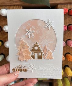 someone holding up a card with some snowflakes on it