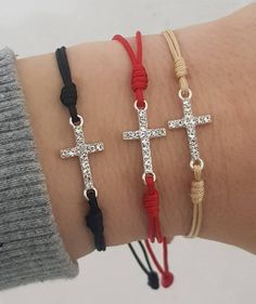 "Bracelet on cord with CZ cross. Cord saints bracelets handmade in Medjugorje. Eache bracelet is made to order, just for you. Bracelet comes in adult size , 10'' (25.5 cm) when fully opened. If you want size for kids , just send us a message. Kids size: 7.5 inch (19 cm) when fully opened. Cord tickeness:1.2 mm Cross: Cubic zirconia Cross size: 2 cm x1 cm At the end is small saint medal. Choose color of cord and saint medal for your bracelet, and it will be made for you. Ideal gifts for ocassions Adjustable Cross Pendant Jewelry, Adjustable Length Cross Jewelry For Gift, Adjustable Cross Jewelry With Adjustable Cord, Rosary Bracelet With Cross And Adjustable Chain For Gifts, Adjustable Cross Jewelry With Cord, Cross Bracelets With Sliding Knot For Gifts, Spiritual Cross Jewelry With Adjustable Cord, Spiritual Cross Bracelets With Sliding Knot, Adjustable Cross-shaped Friendship Bracelets As Gifts