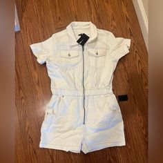 Brand New Never Worn Before White Denim Romper. Front Zipper, Stretchy Waist, Overall Comfortable Stretch Fabric. Does Have A Slight Stain On The Left Pocket (See Pictures) From Being In Storage. Summer White Cotton Denim Jumpsuit, White Cotton Denim Jumpsuit For Summer, Trendy White Denim Jumpsuit With Pockets, Trendy White Cotton Denim Jumpsuit, Trendy White Relaxed Fit Jumpsuits And Rompers, Trendy White Overall Bottoms, White Fitted Cotton Denim Jumpsuit, Fitted White Cotton Denim Jumpsuit, White Casual Denim Jumpsuit