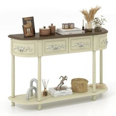 a white console table with two drawers and an open shelf on the top that holds items