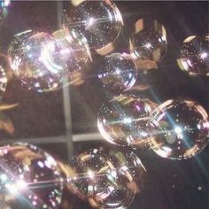 soap bubbles floating in front of a mirror