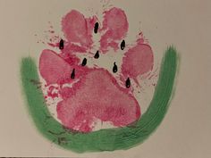 a child's handprint with pink and green paw prints on the inside of it