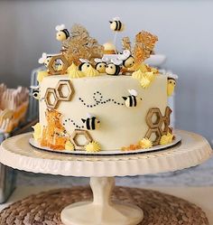 a cake with bees and honeycombs on it sitting on top of a table