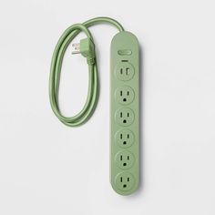 a green power strip sitting on top of a white table