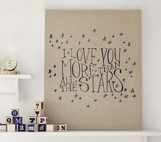 a canvas with the words i love you more than all the stars on it next to wooden blocks