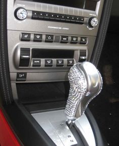 the interior of a car with an automatic gear lever and diamond - embellishments