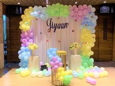 an event with balloons and flowers on the stage for guests to sit down in front of