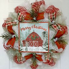 a red and white christmas wreath on a door with the words merry christmas written on it