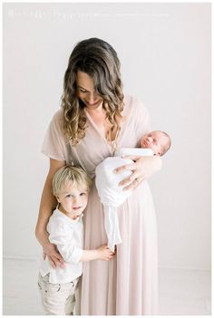 a woman holding a baby in her arms