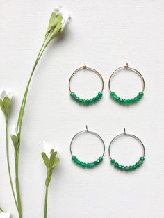 Emerald Hoop Earrings. Ten faceted emeralds adorn each hoop for a total of 20 emeralds in these beautiful earrings! These are perfect with jeans and a t-shirt or to wear with your best outfit! The hoops measure 1-1/4 inches in length and width or just over 3 cm. These earrings are available in either gold plated or rhodium plated finish. Emerald is the May birthstone. Your emerald hoop earrings will arrive gift boxed. If this is a gift, I would be glad to include a card with your personal messag Small Hoop Jewelry With Faceted Beads For Gifts, Faceted Hoop Earrings As Gift, Small Hoop Earrings With Faceted Beads For Gift, Faceted Beads Dangle Hoop Earrings For Gifts, Gift Hoop Earrings With Faceted Beads, Earrings Gold Hoop, Earrings Emerald, Hoop Earrings Silver, Hoop Earrings Gold