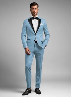 Bring some passion to your wardrobe with our finely tailored Napolean Taj Blue Wool Tuxedo suit. Crafted from wool blend, the luxurious feel of the tuxedo for sure will give you that perfect warmth while the neutral tone will add further depth and character to an otherwise all-black ensemble.  Featuring satin lapel, matching satin covered buttons and gentle texture at its surface, our tuxedo is a subtle fashion-forward take on a traditional tailoring.  Look Includes   Napolean Taj Blue Wool Fabric  Two Button Tuxedo Jacket Style  Notch Lapel  Black Tuxedo Buttons  Single Vent  Three Cuff Buttons  Two Welted Back Pockets on Trousers   Click 'Customize Now' to modify the look if needed.  Jacket is fully lined while the Pants do not have satin lining.  Lining: Viscose; Dry Clean. Blue Single Breasted Tuxedo In Suiting Fabric, Blue Single-breasted Tuxedo In Suiting Fabric, Custom Fit Tuxedo Suits For Tailoring, Bespoke Fitted Single-breasted Tuxedo, Blue Tuxedo Blazer For Black-tie Events, Tailored Blue Three-piece Suit For Formal Occasions, Luxury Blue Suits For Black-tie Events, Elegant Blue Double Breasted Suit With Single Button, Tailored Blue Tuxedo Suit