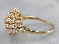 Many small parts create the whole in this vintage diamond ring. These diamonds have excellent color, and arranged together this way they form a sweet linear cluster in one sparkling profile! This fantastic vintage piece is crafted of highly polished yellow gold and is ready to wear or gift! Metal: 14K Yellow Gold Gem: 45 Diamonds totaling 2.92 Carats, G in Color, SI1 in Clarity Gem Measurements: 3.1 mm, Round (center stone) Ring Size: 7.25 Classic Yellow Gold Cluster Diamond Ring, Cluster Diamond Ring With Prong Setting, Yellow Gold Diamond Cluster Ring, Cluster Yellow Gold Diamond Ring With Prong Setting, Yellow Gold Cluster Diamond Ring With Prong Setting, Luxury Vintage Gold Cluster Ring, Vintage Multi-stone Diamond Ring For Collectors, Vintage Yellow Gold Cubic Zirconia Cluster Ring, Vintage Gold And Platinum Cocktail Rings