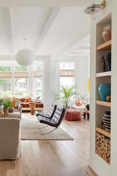 a living room filled with furniture and lots of windows