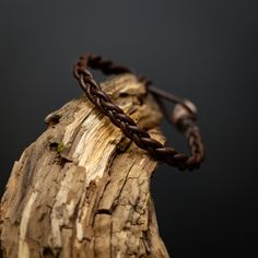 Traditional Handmade Braided Bracelet   The brown leather braid with the bead end has a earhty color and giving the bracelet a exclusive contrast, and timeless design. Thickness about 2mm Width about 6mm Find your size by measuring around your wrist. Keep it thight but not uncomfortable, the bracelet will be made loose after your size. If your size is not in the menu. Don't hesitate to send me your desired size. Use this list to convert inches to the size menu. 5,5" -                 14 cm 5,7" Casual Brown Leather Braided Bracelet, Brown Braided Leather Jewelry, Bohemian Brown Hand-wrapped Braided Bracelet, Unique Hand-tooled Brown Leather Bracelet, Masculine Brown Leather Braided Bracelet, Braided Leather, Leather Handmade, Brown Leather, Timeless Design