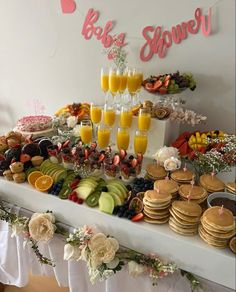 an assortment of desserts and drinks on a table at a brunch party