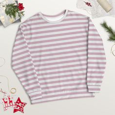 Treat yourself or a loved one to the ultimate cozy wardrobe staple! This pink striped shirt is made from a soft and durable material that feels great to wear. Plus, the inside's brushed fleece gives an extra comfy feel.  Whether you're running errands or having a relaxing night in, this crewneck sweatshirt is the perfect gift for any woman.  Get your hands on it now and experience true comfort and style! ⚠️ PLEASE NOTE: ⚠️ 🎅🏼 To ensure that your package has the best possible chance of arriving in time for 🎄Christmas: ⭐️ For deliveries to the United States, please order before December 11th; ⭐️ For deliveries to Europe, please order before December 14th. ✨ SPECIFICATIONS ✨ * 95% recycled polyester, 5% spandex * Fabric weight (may vary by 5 9.08 oz./yd.² (308 g/m²) * Soft cotton-feel fabr Casual Long Sleeve Striped Sweater, Striped Sweatshirt For Loungewear In Fall, Striped Long Sleeve Sweatshirt For Winter, Striped Crew Neck Top For Winter, Striped Sweatshirt With Ribbed Cuffs For Winter, Striped Relaxed Fit Sweatshirt For Winter, Winter Long Sleeve Striped Top, Striped Sweatshirt For Fall Loungewear, Striped Crew Neck Sweatshirt For Loungewear