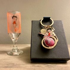 a wine glass and keychain sitting next to each other