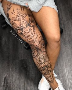 a woman's legs with tattoos on them