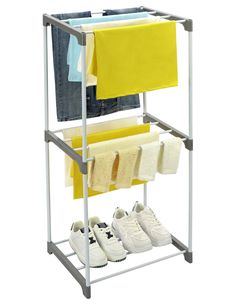 a rack with two pairs of shoes and clothes hanging on the rail, next to some folded jeans