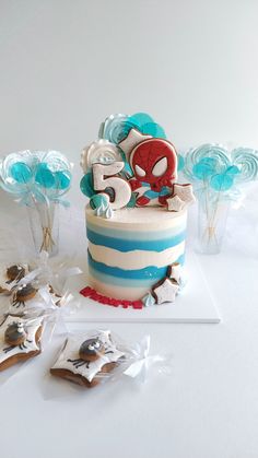 a spiderman birthday cake with blue and white icing