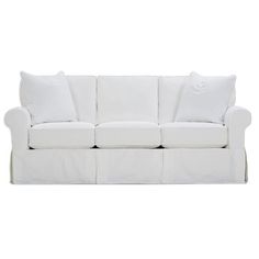 a white couch with pillows on top of it and the bottom half covered in linen