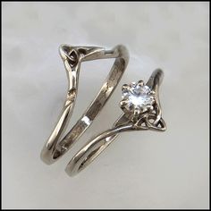 two silver rings with a diamond in the middle