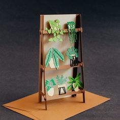 an easel with paper cut out of plants on it