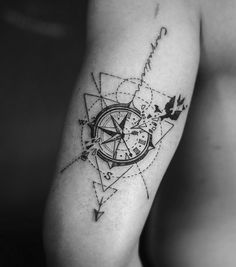 a man with a compass tattoo on his arm