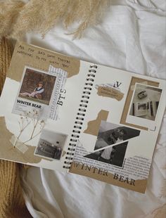 an open book with pictures on it sitting on top of a white bed sheet next to a pile of yarn