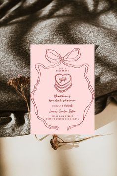 a pink wedding card with a bow on it