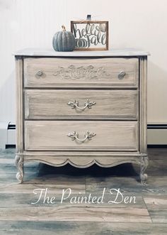 an old dresser with the words painted den on it's top and bottom drawer