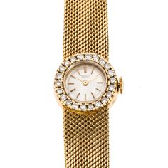 This elegant ladies' watch is ideal for a special night out or simply as a collectable piece. It is an 18K yellow gold International Watch Co. Swiss-made timepiece, with a round shaped champagne coloured dial, yellow stick hour markers and hands, and finished with an 18K gold tapered mesh bracelet with fold-over clasp. Adding to the elegant timepiece are 22 diamonds totaling 0.55 carats (clarity: VS - SI; colour: I-J) that surround the bezel. Measures approximately 6.5" in length. Gram weight: 3 Yellow Gold Diamond Watch With Round Dial For Anniversary, Anniversary Yellow Gold Diamond Watch With Round Dial, Formal Yellow Gold Diamond Watch, Formal Yellow Gold Diamond Watch With Round Dial, Yellow Gold Watch With Round Dial For Evening, Classic Yellow Gold Diamond Watch For Evening, Yellow Gold Diamond Watch With Diamond Hour Markers, Yellow Gold Diamond Watch With Round Face, Diamond Watch With Jubilee Bracelet