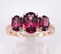 three stone ring set in yellow gold with pink tourmaline and white topaz