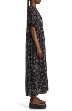 This soft T-shirt maxi is crafted in an oversized silhouette with an allover print and elbow-length sleeves. Crewneck Elbow-length sleeves Lined 100% polyester Hand wash, line dry Imported Black Short Sleeve Maxi Dress For Loungewear, Oversized Casual Maxi Dress For Daywear, Casual Oversized Maxi Dress For Daywear, Oversized Graphic Print Short Sleeve Dress, Spring Maxi Dress With Graphic Print And Short Sleeves, Black Relaxed Fit Maxi Dress For Loungewear, Dressed In Lala, Oversize T Shirt, Maxi Shirt Dress