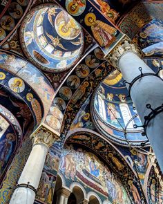 the interior of an ornate building with painted walls and ceiling murals on it's sides