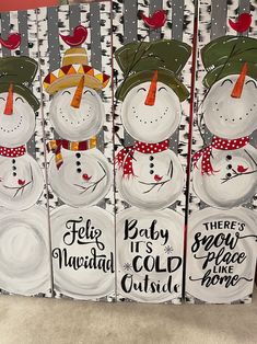 three snowmen with hats and scarfs on their heads are painted on wood boards